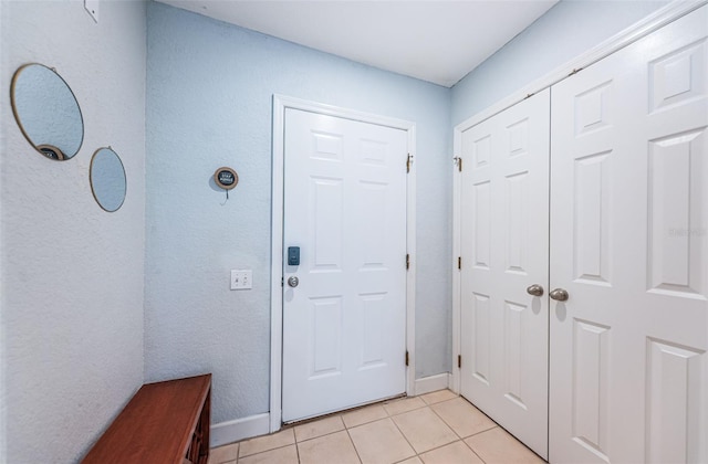 805 100th Ave N, Saint Petersburg, FL 33702 - doorway to outside featuring light tile patterned flooring and baseboards