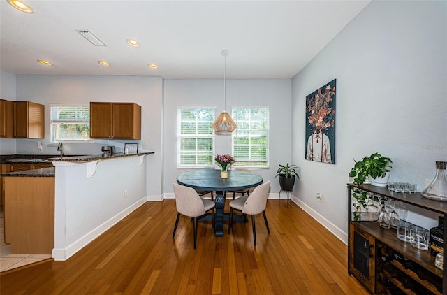 805 100th Ave N, Saint Petersburg, FL 33702 - dining area with visible vents, baseboards, plenty of natural light, and wood finished floors