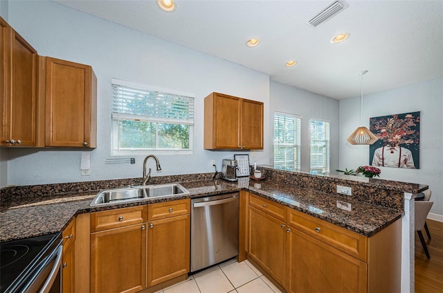 805 100th Ave N, Saint Petersburg, FL 33702 - kitchen featuring brown cabinetry, a peninsula, dishwasher, and a sink