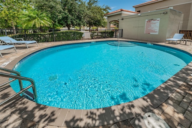 805 100th Ave N, Saint Petersburg, FL 33702 - pool featuring a patio and fence