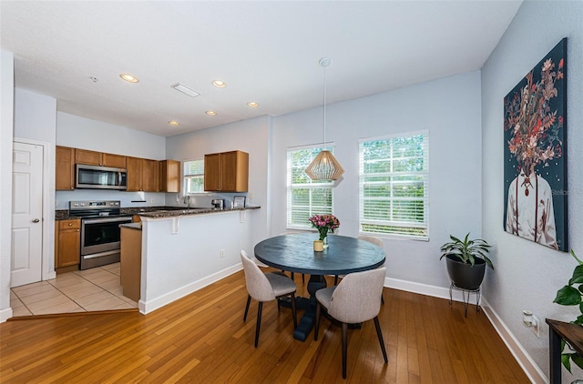 805 100th Ave N, Saint Petersburg, FL 33702 - dining room with recessed lighting, light wood-style flooring, and baseboards