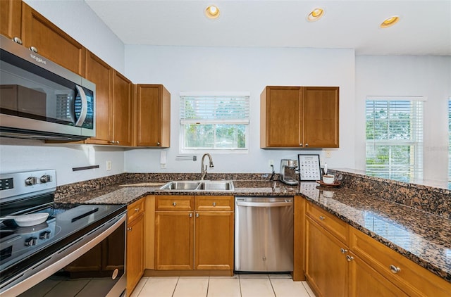 805 100th Ave N, Saint Petersburg, FL 33702 - kitchen with a healthy amount of sunlight, brown cabinets, a sink, and appliances with stainless steel finishes