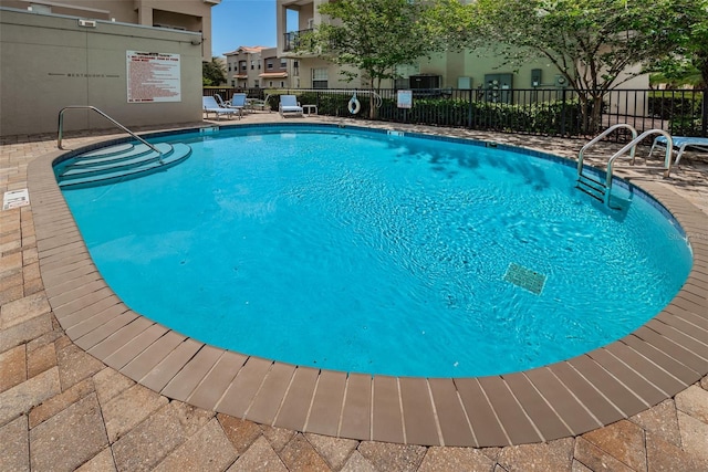 805 100th Ave N, Saint Petersburg, FL 33702 - community pool with a patio and fence