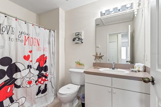 bathroom with toilet, tile patterned floors, vanity, and curtained shower