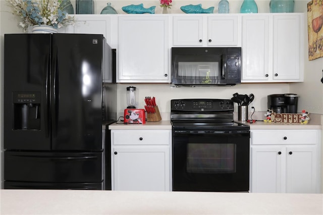 151 Pompano Beach Dr, Kissimmee, FL 34746 - kitchen with black appliances, light countertops, and white cabinetry