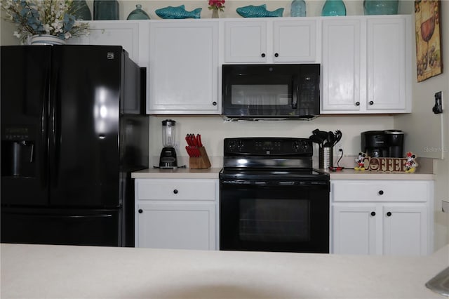 151 Pompano Beach Dr, Kissimmee, FL 34746 - kitchen with black appliances, light countertops, and white cabinets