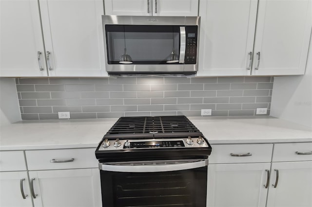 445 31st Way N, Saint Petersburg, FL 33713 - kitchen with light countertops, white cabinetry, appliances with stainless steel finishes, and tasteful backsplash