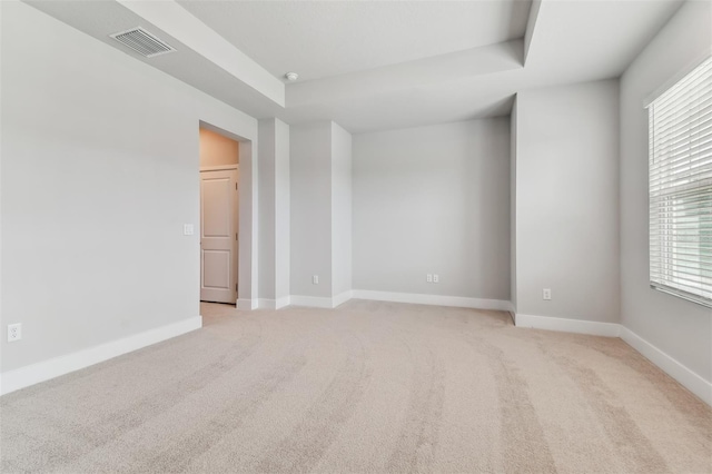 445 31st Way N, Saint Petersburg, FL 33713 - spare room with visible vents, a raised ceiling, baseboards, and light carpet