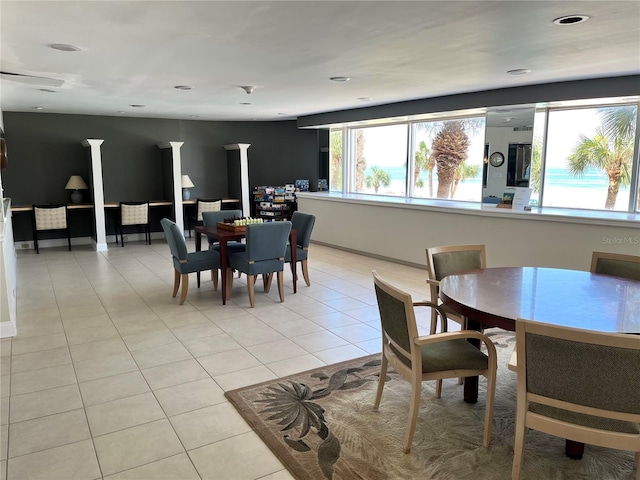 dining room featuring light tile patterned floors and baseboards
