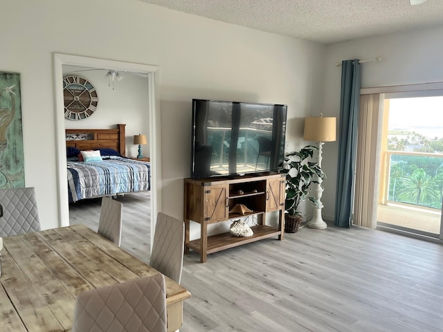 bedroom featuring light wood-style flooring and a textured ceiling