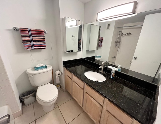 full bathroom featuring toilet, vanity, tile patterned flooring, and walk in shower