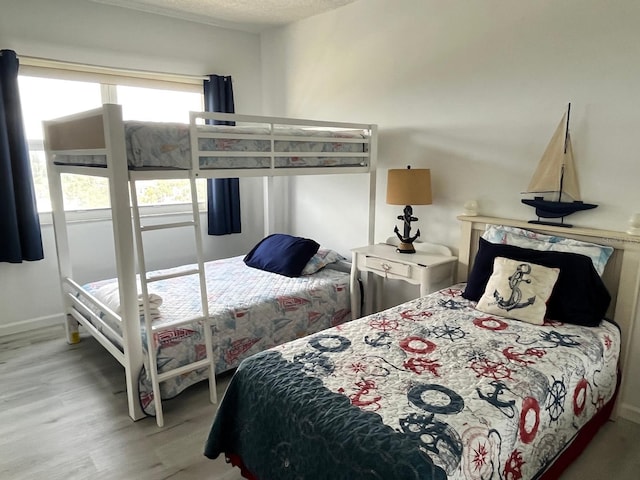 bedroom featuring a textured ceiling and wood finished floors