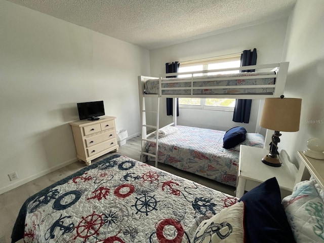 bedroom featuring a textured ceiling and baseboards