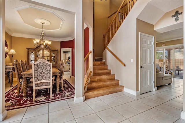 10003 Vista Pointe Dr, Tampa, FL 33635 - dining room with a chandelier, stairway, crown molding, light tile patterned floors, and baseboards