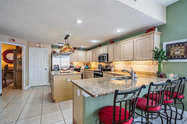 10003 Vista Pointe Dr, Tampa, FL 33635 - kitchen featuring a sink, appliances with stainless steel finishes, a peninsula, a center island, and tasteful backsplash