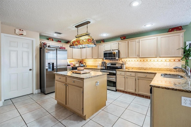 10003 Vista Pointe Dr, Tampa, FL 33635 - kitchen featuring appliances with stainless steel finishes, a sink, a center island, tasteful backsplash, and light stone countertops