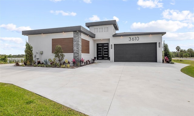 3610 Gulf City Rd, Ruskin, FL 33570 - view of front of property featuring stucco siding, concrete driveway, and an attached garage