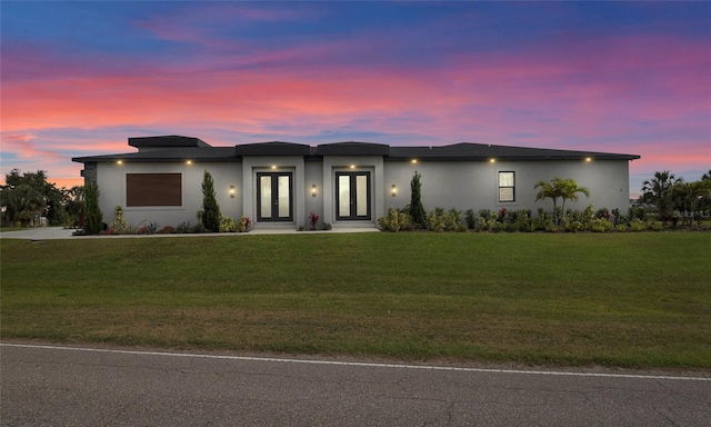 3610 Gulf City Rd, Ruskin, FL 33570 - view of front of home with a yard, stucco siding, and french doors