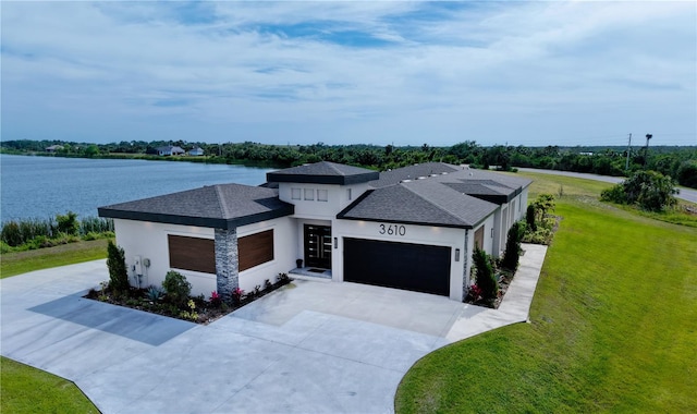 3610 Gulf City Rd, Ruskin, FL 33570 - prairie-style home featuring a front yard, a shingled roof, stucco siding, concrete driveway, and an attached garage