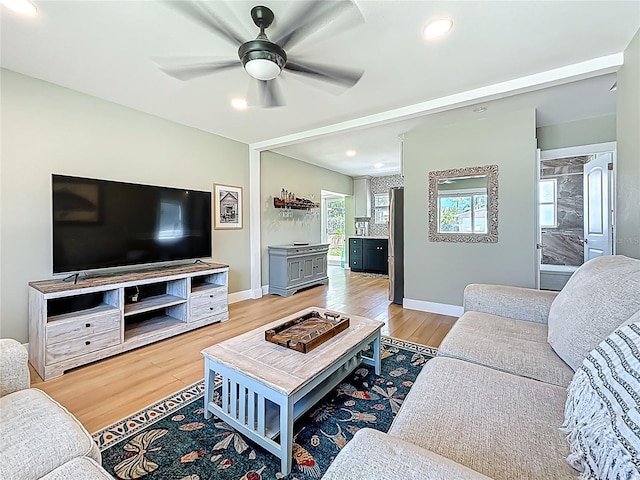 living area featuring baseboards, recessed lighting, wood finished floors, and ceiling fan