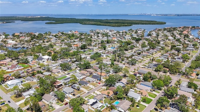 drone / aerial view featuring a residential view and a water view