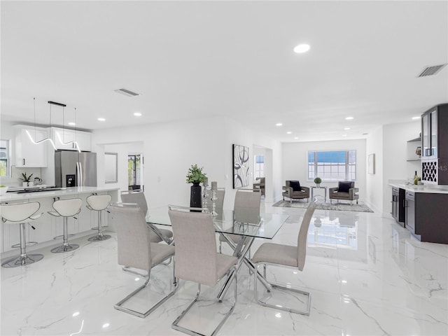 dining area featuring visible vents, recessed lighting, and marble finish floor