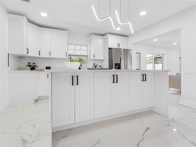 kitchen with stainless steel fridge with ice dispenser, recessed lighting, marble finish floor, and plenty of natural light