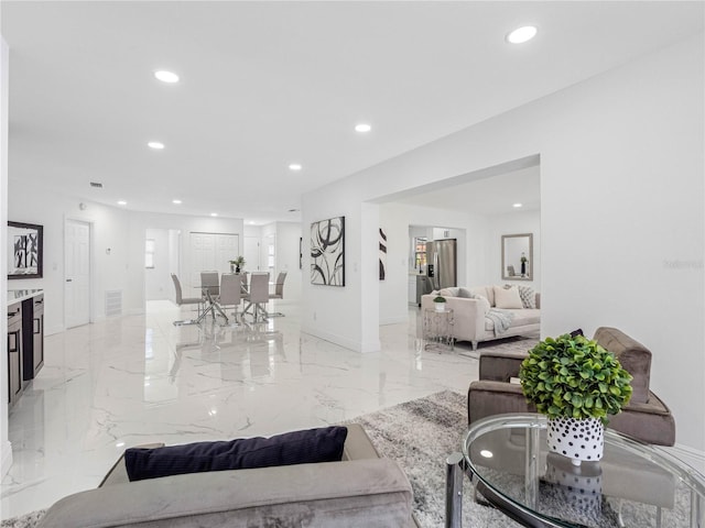 living area with marble finish floor, baseboards, visible vents, and recessed lighting