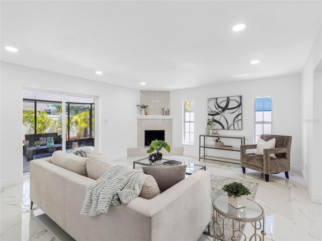 living area featuring marble finish floor, a fireplace, baseboards, and recessed lighting