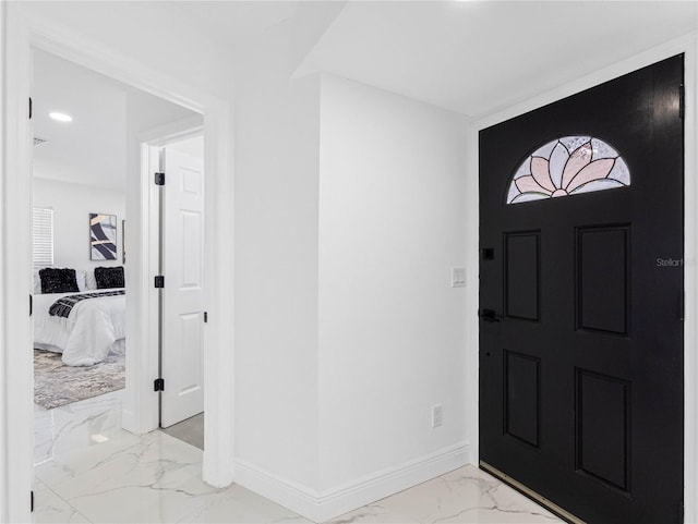 foyer entrance featuring recessed lighting, marble finish floor, and baseboards