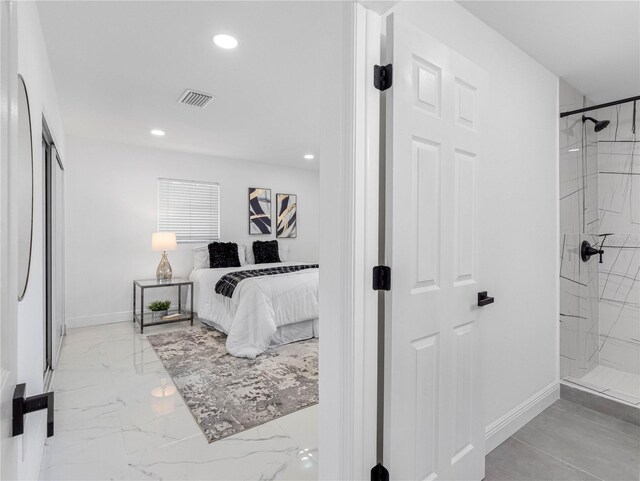 ensuite bathroom with a marble finish shower, visible vents, baseboards, and recessed lighting
