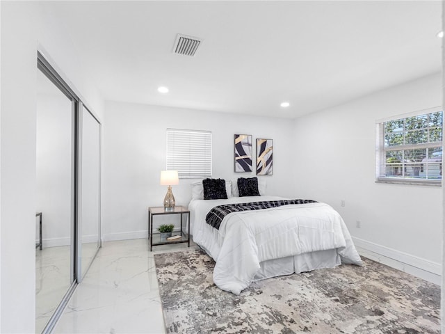 bedroom featuring a closet, baseboards, recessed lighting, visible vents, and marble finish floor