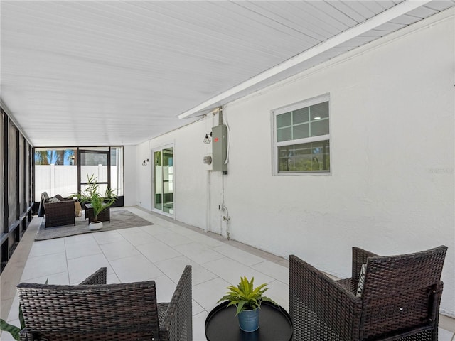 sunroom / solarium featuring tile patterned flooring and an outdoor hangout area