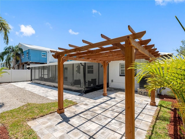 view of patio with a sunroom, a pergola, and fence