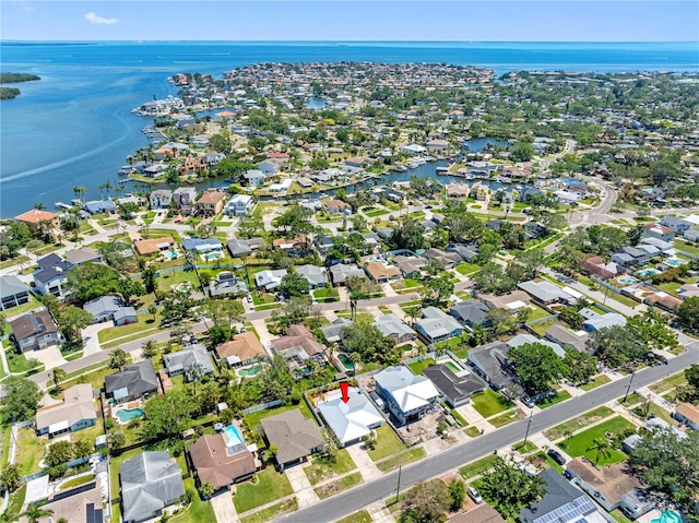 drone / aerial view with a water view and a residential view