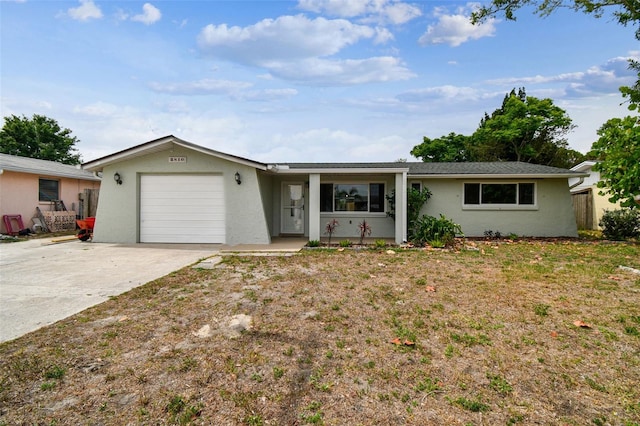 ranch-style home featuring concrete driveway, stucco siding, and a garage