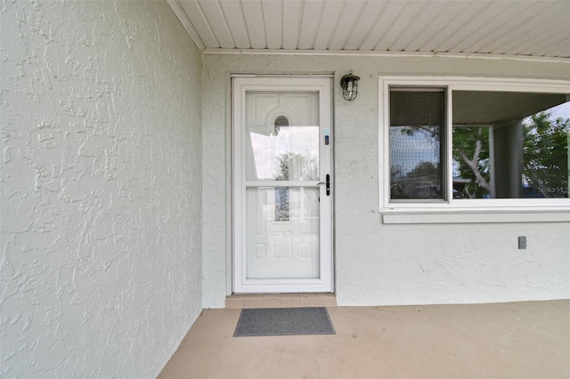 doorway to property with stucco siding