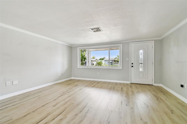 entryway featuring ornamental molding, wood finished floors, and visible vents