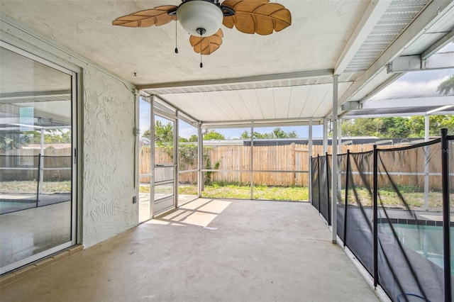 unfurnished sunroom with a ceiling fan