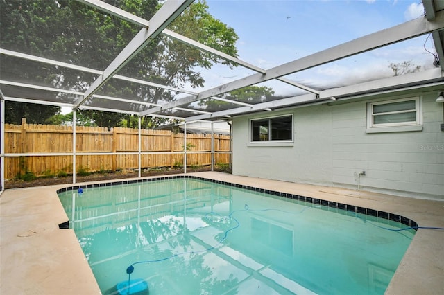 view of swimming pool with a fenced in pool, a lanai, and fence