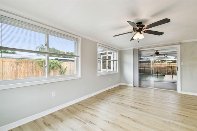spare room featuring a ceiling fan, baseboards, and wood finished floors