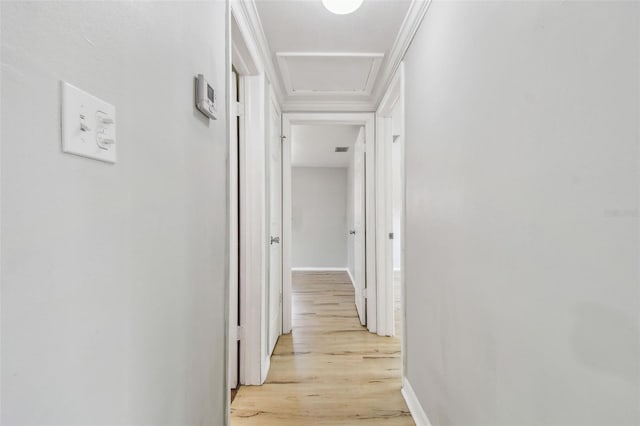 hall featuring attic access, baseboards, light wood-type flooring, and visible vents
