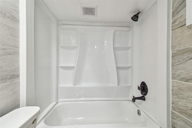 bathroom featuring visible vents, toilet, and shower / washtub combination