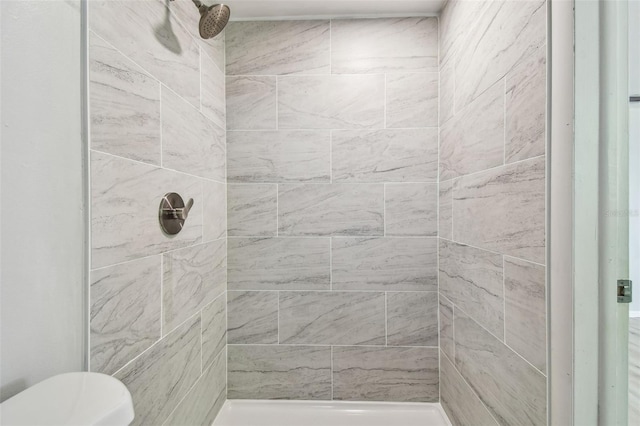 full bathroom with a tile shower
