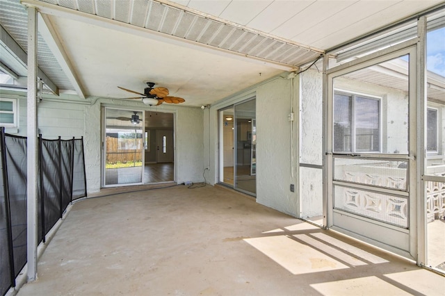 unfurnished sunroom with a ceiling fan