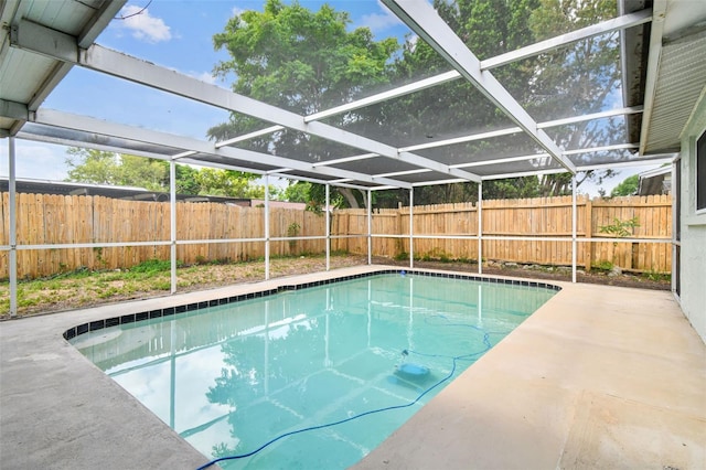 view of swimming pool featuring a fenced in pool, a patio, a fenced backyard, and glass enclosure