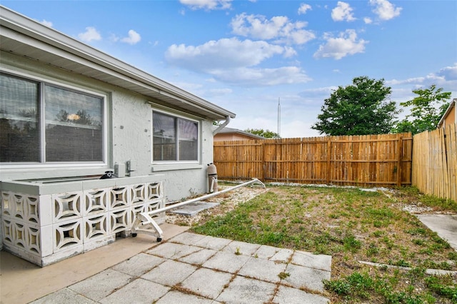 view of yard featuring fence and a patio