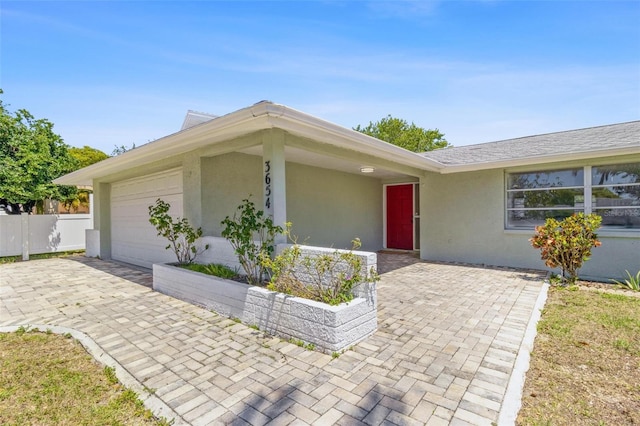 3654 Warbler Dr, New Port Richey, FL 34652 - single story home featuring an attached garage, fence, decorative driveway, and stucco siding