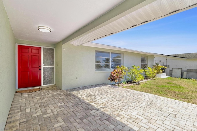 3654 Warbler Dr, New Port Richey, FL 34652 - entrance to property with stucco siding and a patio