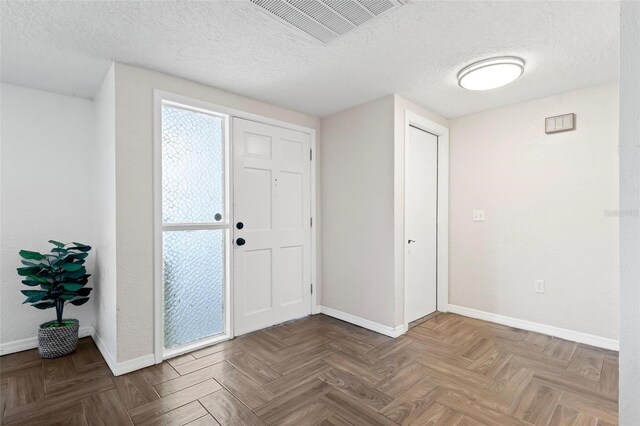 3654 Warbler Dr, New Port Richey, FL 34652 - entryway with baseboards, a textured ceiling, and visible vents
